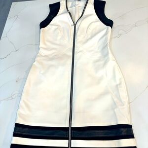 Yigal Azrouel White with black leather trim. Zipper pulls down & up from bottom.